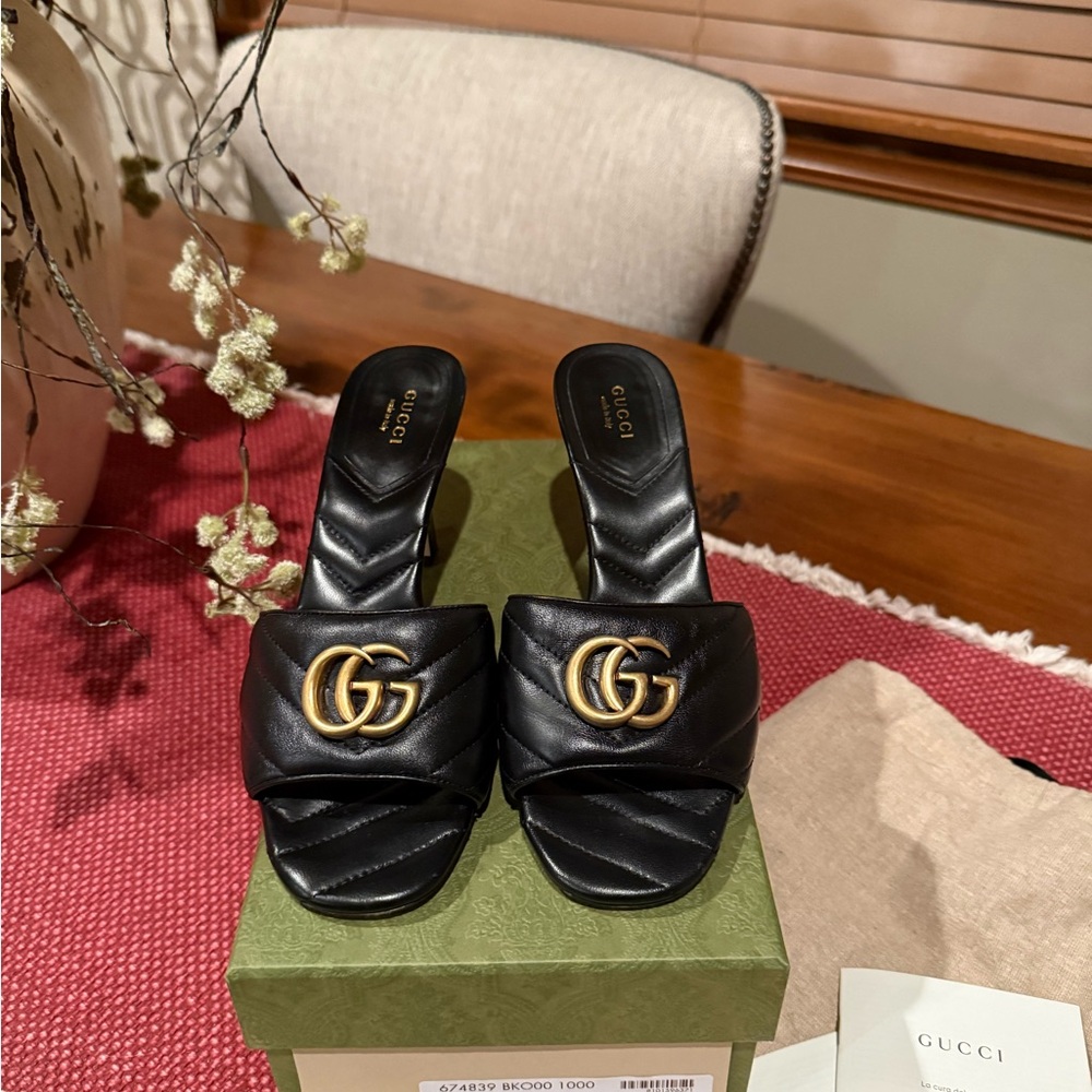 Gucci Black Leather Mules with Gold Emblem
